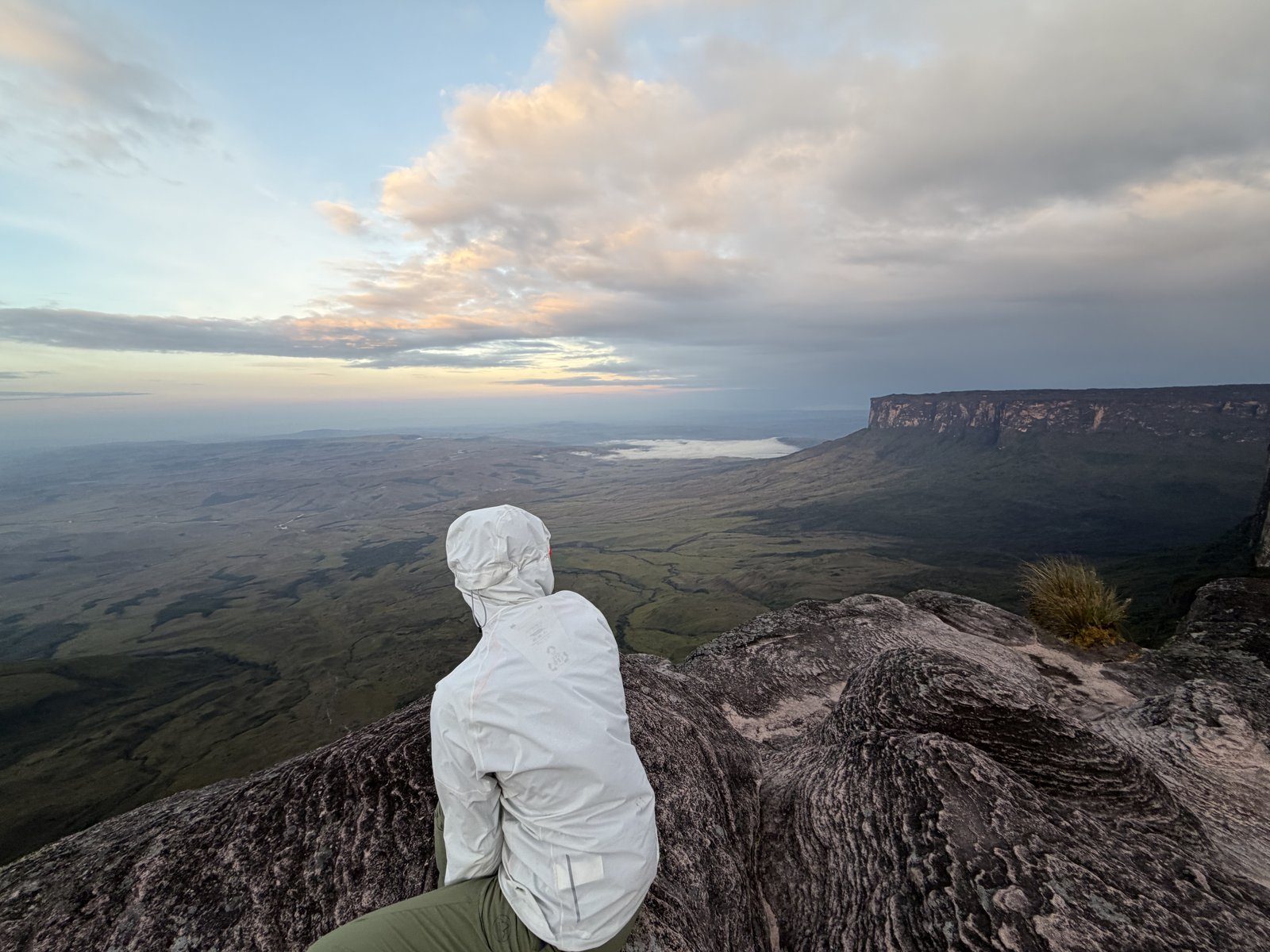 Excursionista contemplando el mar de nubes al atardecer